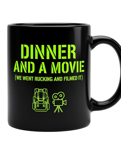 Black 11oz ceramic mug with phosphor green stencil text reading DINNER AND A MOVIE (WE WENT RUCKING AND FILMED IT)