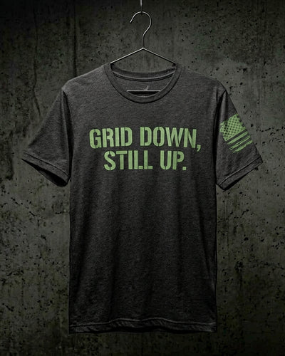 GRID DOWN STILL UP tee in heather charcoal with phosphor green stencil front print and reverse-field tattered American flag on the sleeve