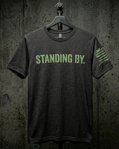 STANDING BY tee in heather charcoal with phosphor green stencil front print and reverse-field tattered American flag on the sleeve